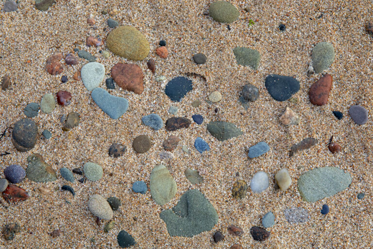 Ocean stones in the sand on a beach in Cape Breton
